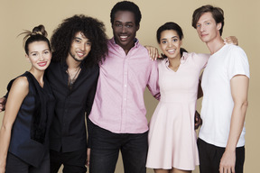 Company of interracial friends hugging and smiling