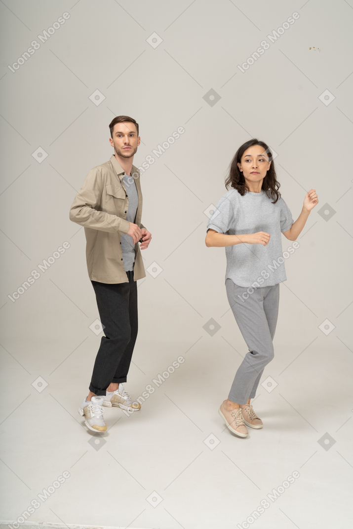 Two young people doing a dance move