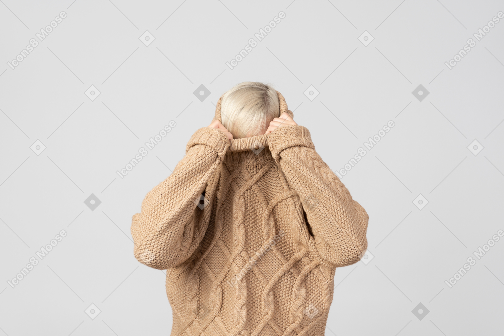 Young woman taking off her sweater