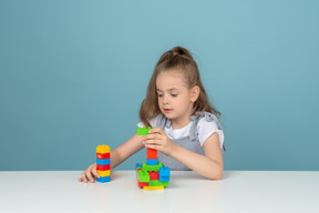 Little girl playing with building blocks