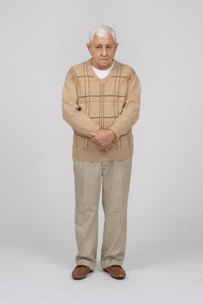 Front view of an old man in casual clothes standing still