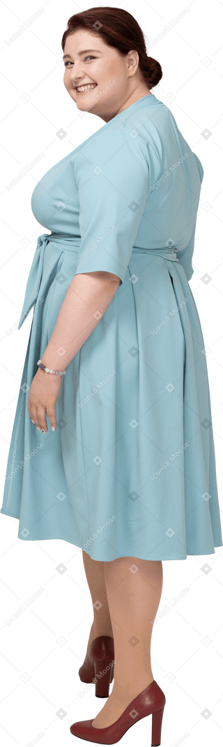 Side view of a happy woman in blue dress