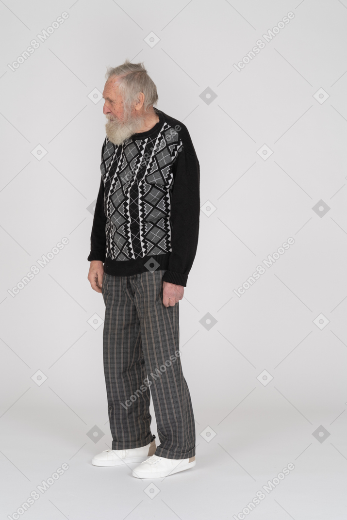 Elderly man standing and looking aside