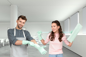 A man and a woman cleaning a room