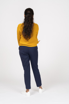 Rear view of a girl in casual clothes