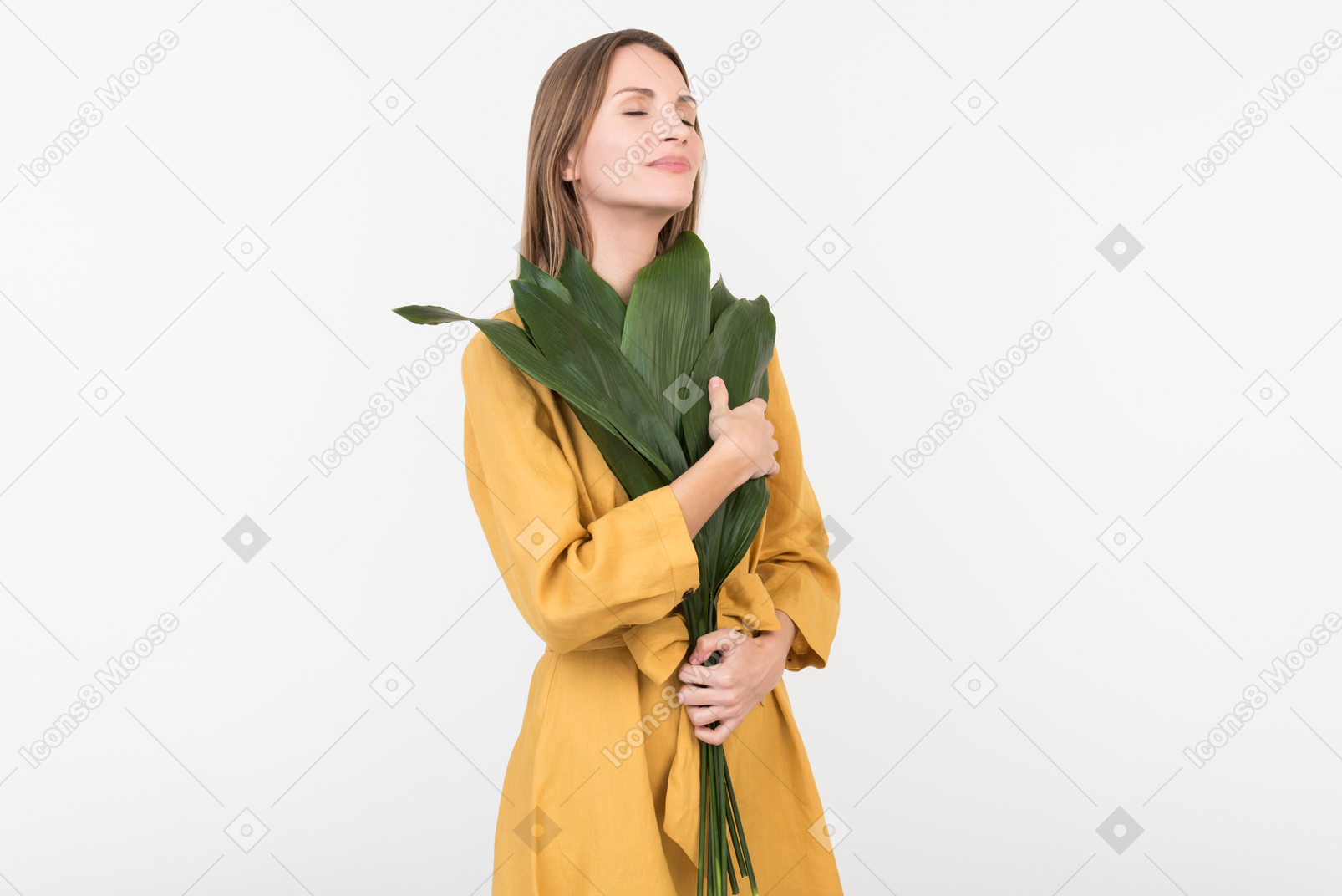 Young woman holding green branch close to her