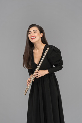 A smiling woman holding a flute