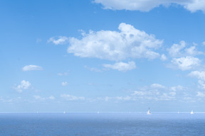 Scenic view of boats sailing on a sunny day