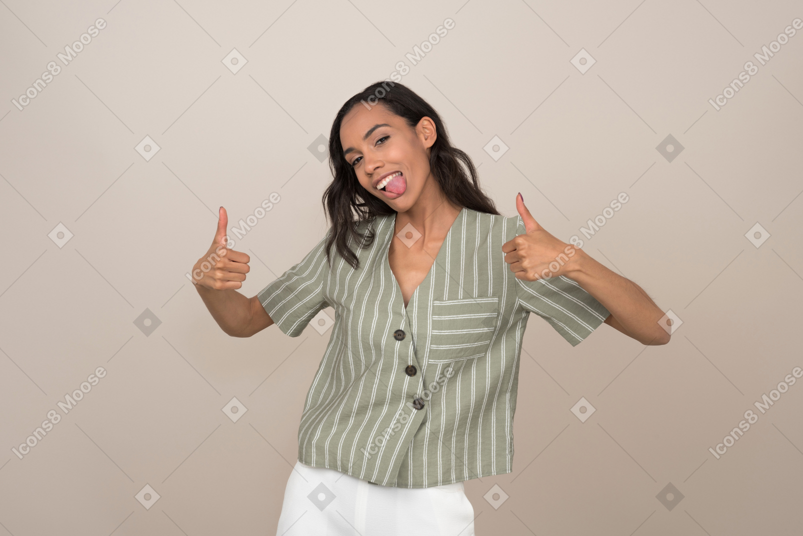 Attractive girl with a tongue out showing a thumb up