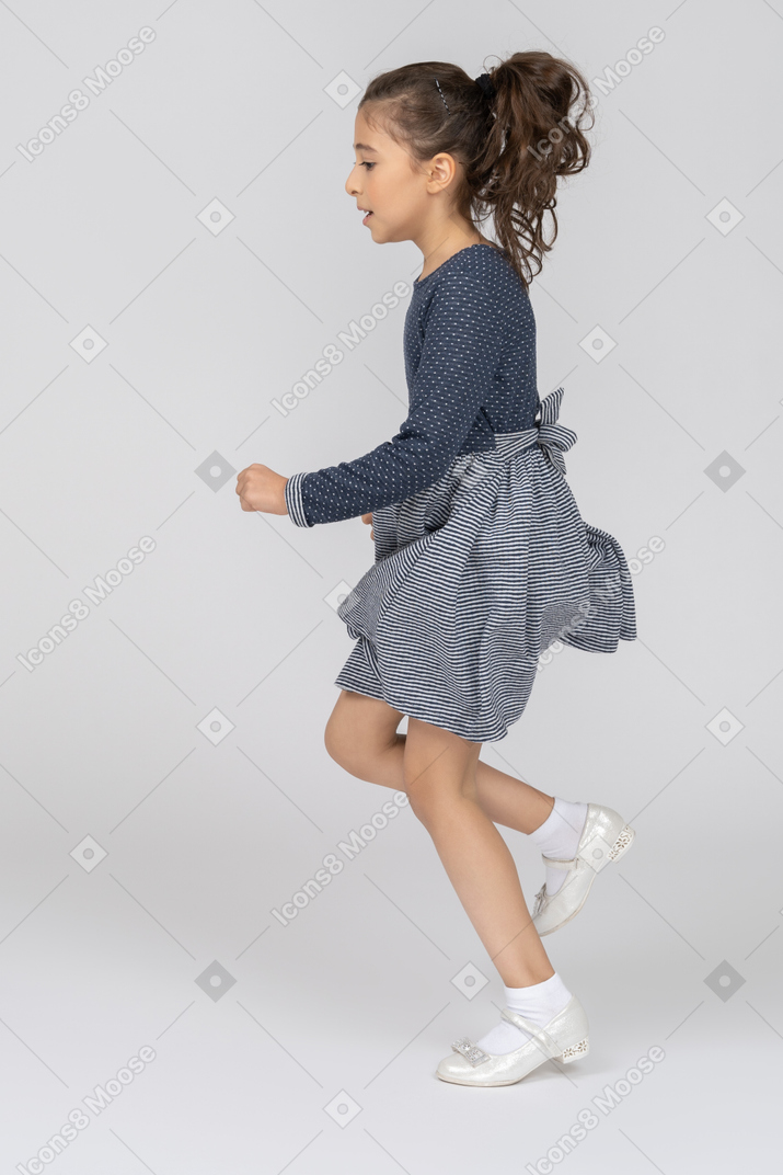 Side view of a girl running in motion