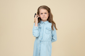 Menina bonitinha falando ao telefone