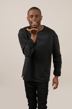 Young man blowing a kiss and smiling