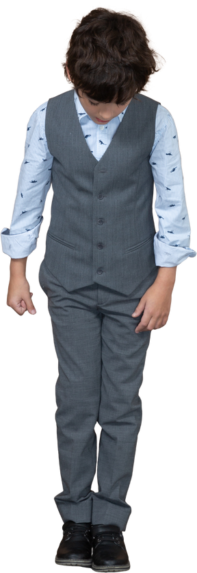 Front view of a boy in suit looking down