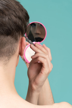 Close-up of a person applying make up