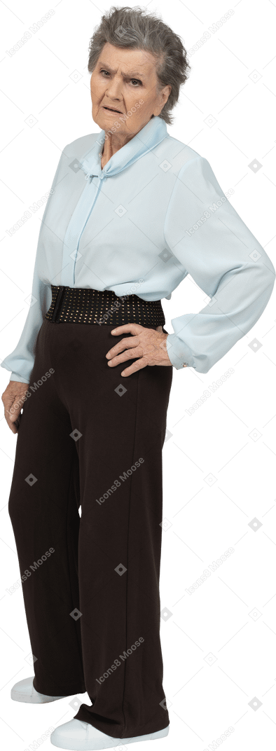 Front view of an angry old woman putting hand on hip