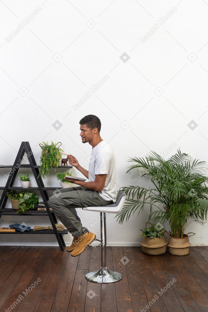 Good looking young man sitting on a chair