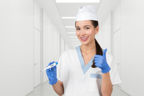 Satisfied doctor with a thermometer in his hands