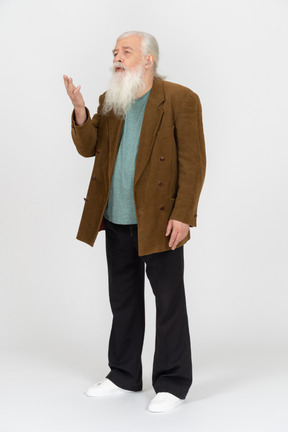 Gray-haired man raising his hand while talking