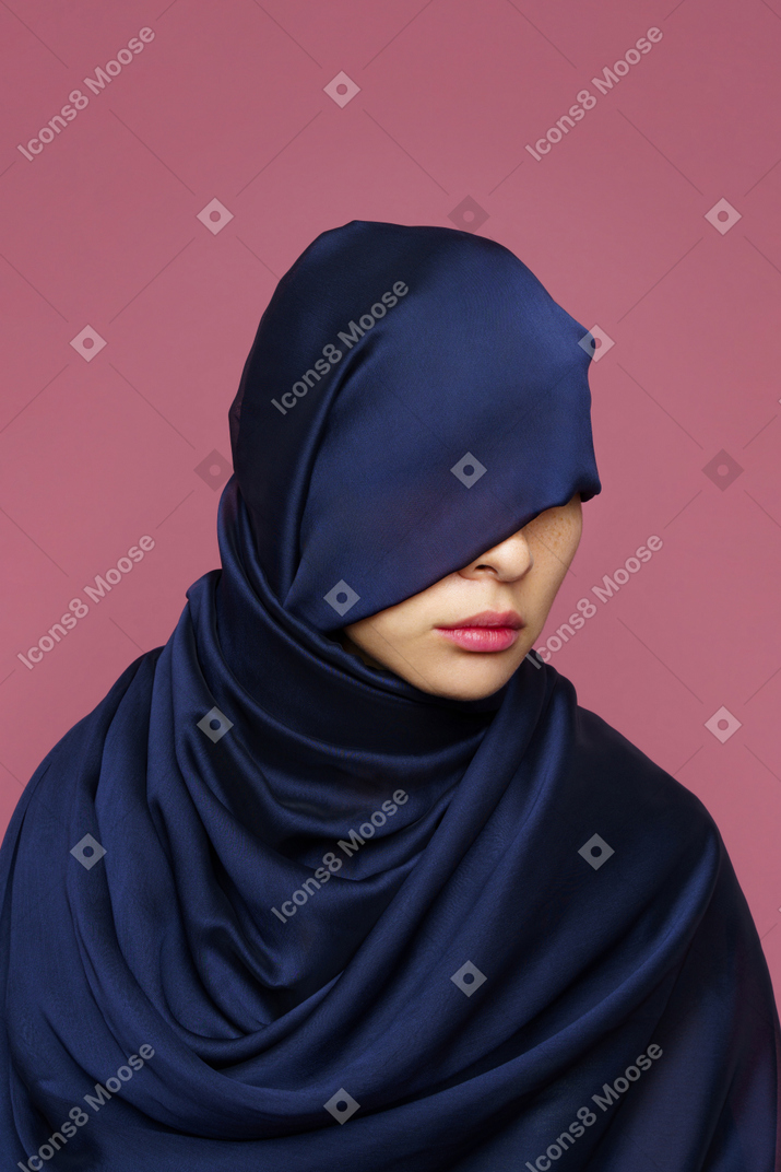 Close-up a young female wrapped in dark blue cloth