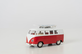 Hippie toy autobus photographed sideways on grey background