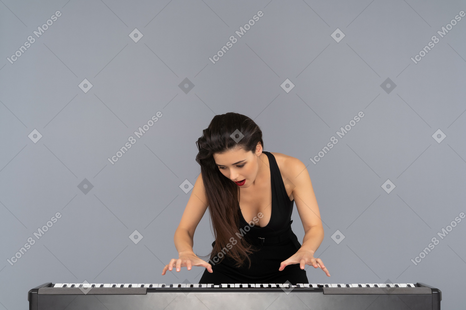 Beautiful female pianist getting ready to play