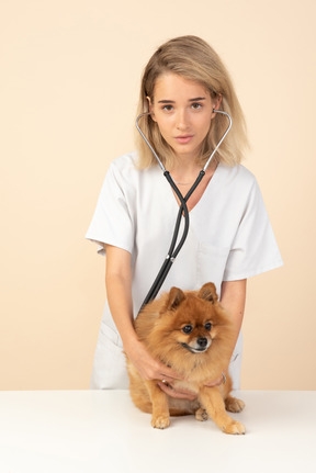 Attractive veterenarian examining a spitz