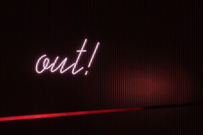 Neon sign out! in a dark interior