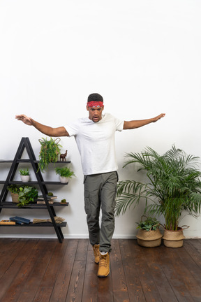 Good looking young man posing on the background of the apartment