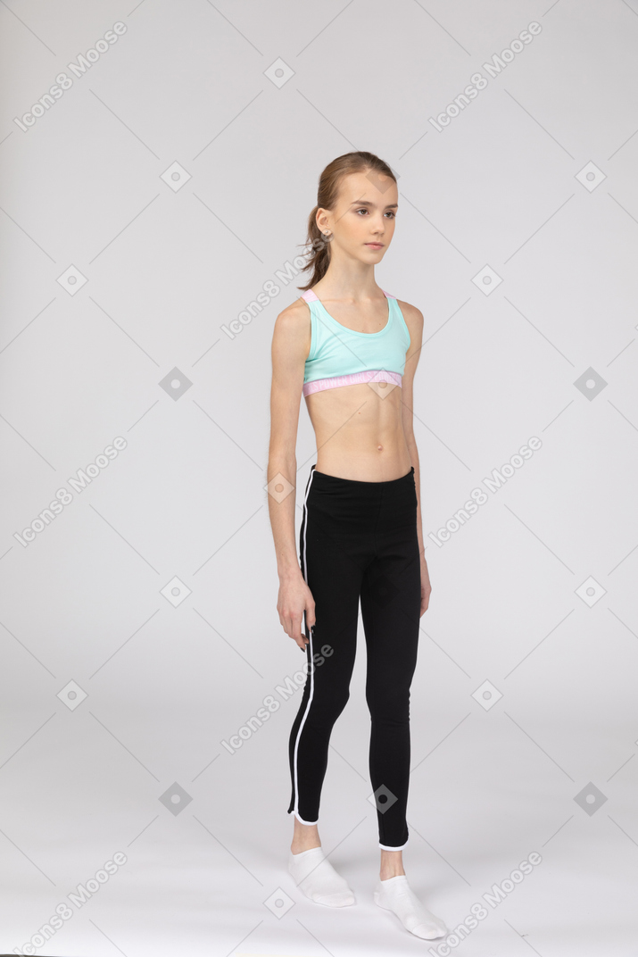 Three-quarter view of a teen girl in sportswear walking