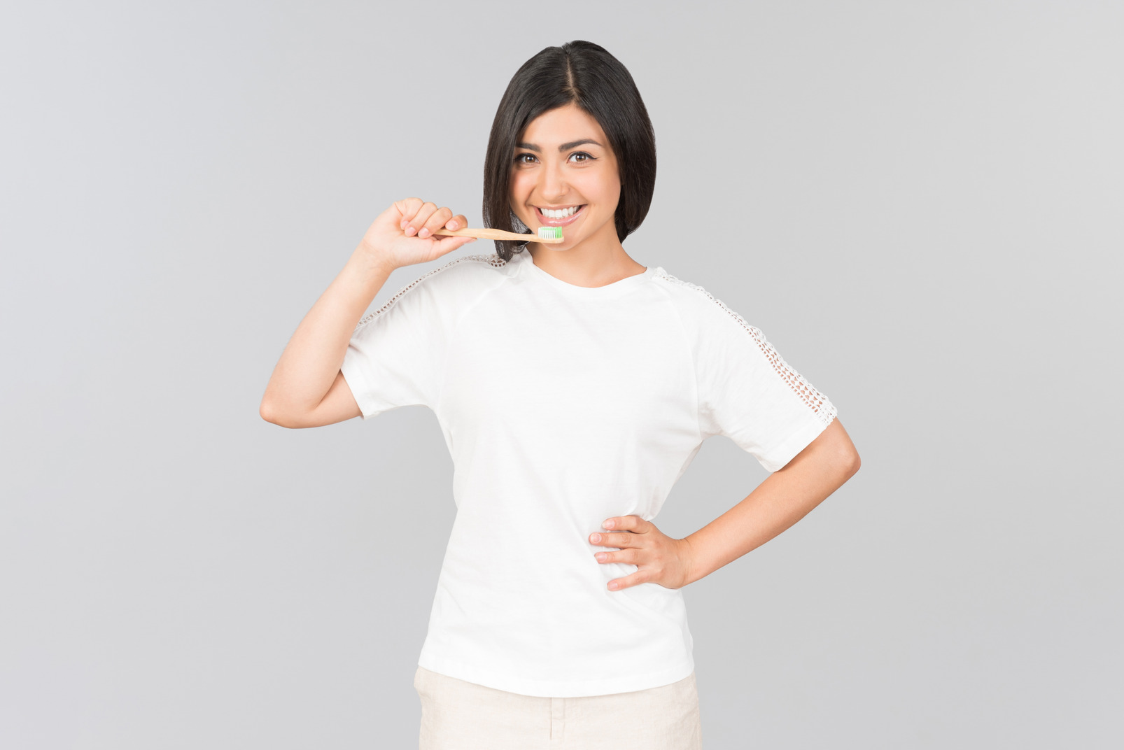 Young indian woman holding toothbrush next to her mouth