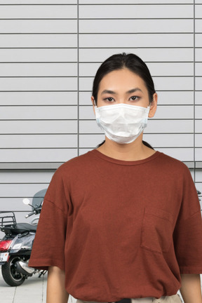 A woman wearing a face mask outside