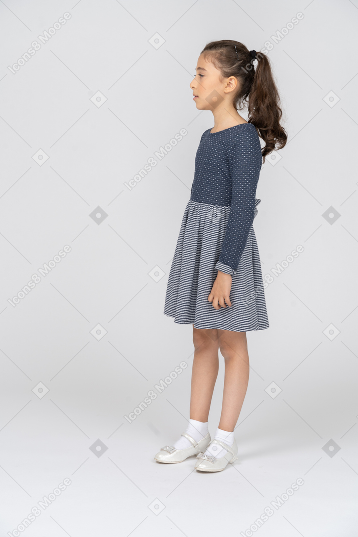 Three-quarter view of a girl standing straight