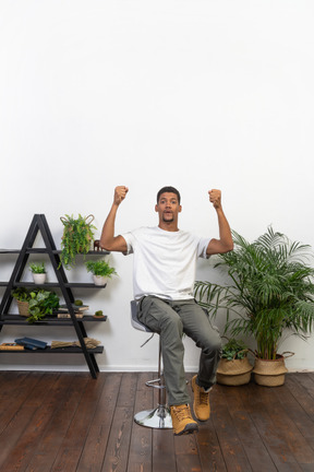 Good looking young man sitting on a chair