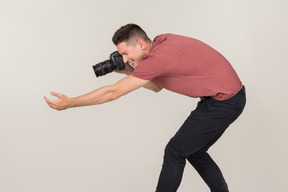 Young guy taking photos with a camera