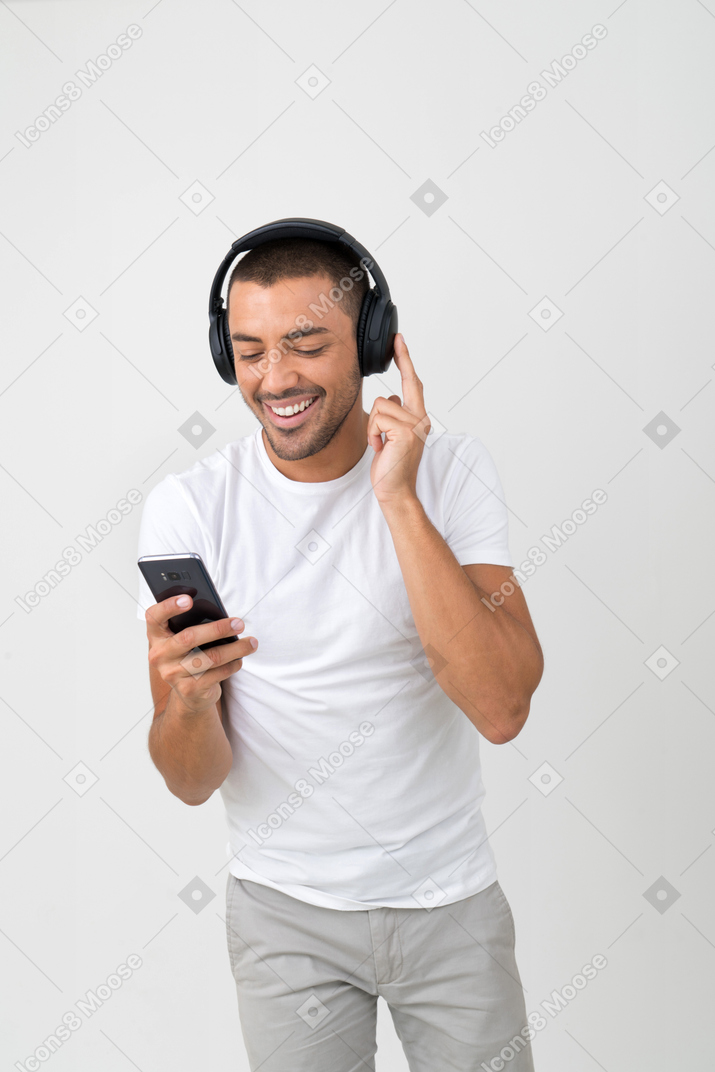 Listening to music on his phone