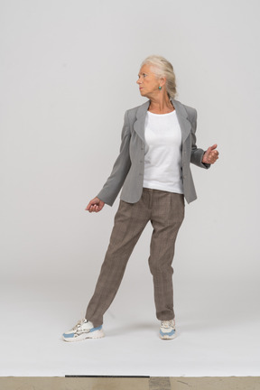 Front view of an old lady in suit dancing