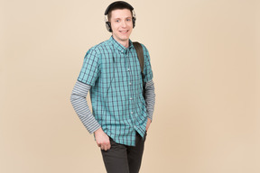 Smiling student standing with a backpack and headphones
