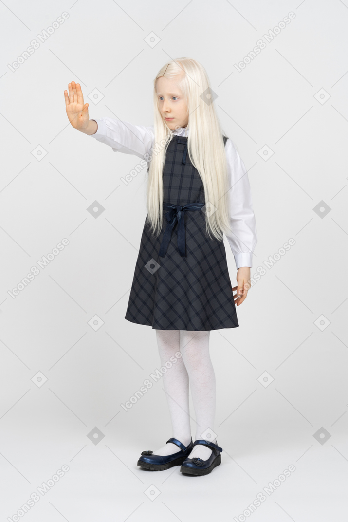 Schoolgirl putting a hand in front of herself