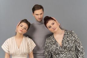 Young man touching women's heads