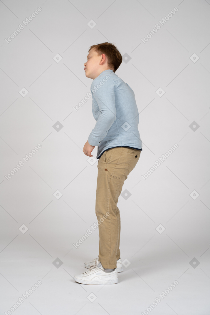Side view of a boy suffering from stomachache