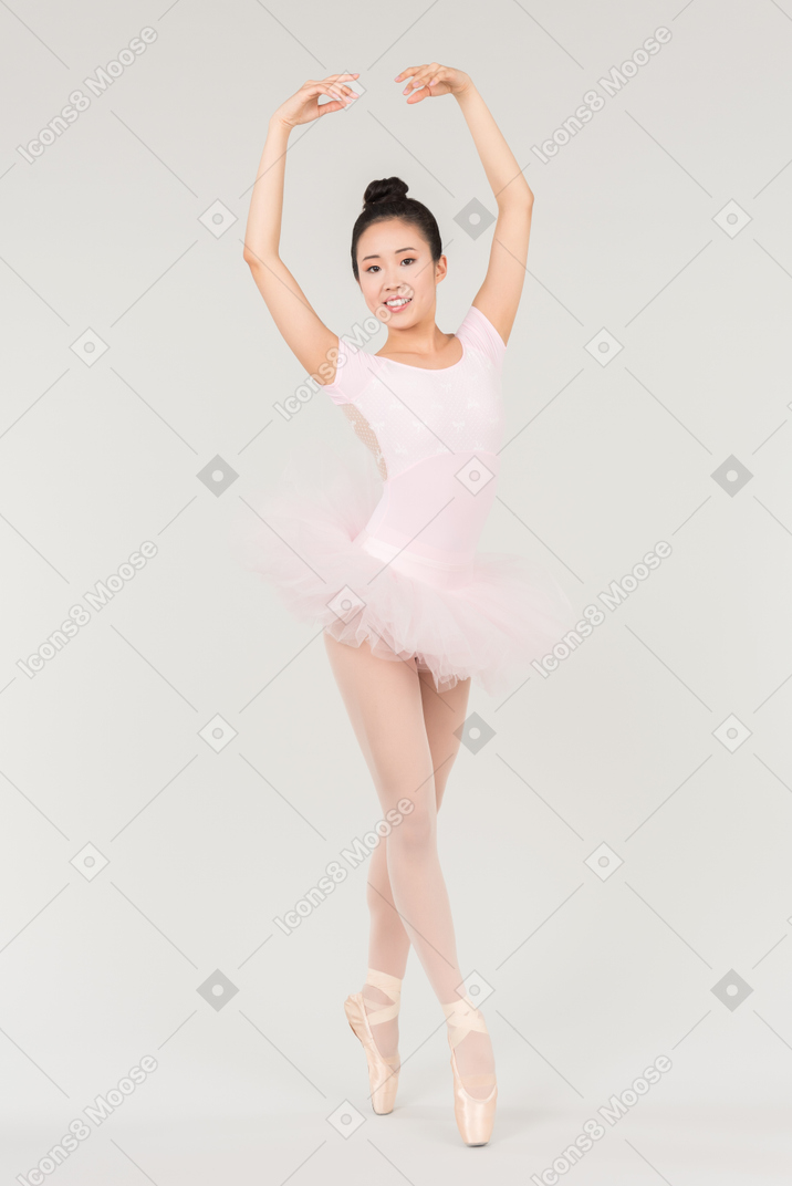Young asian ballerina standing in dance position