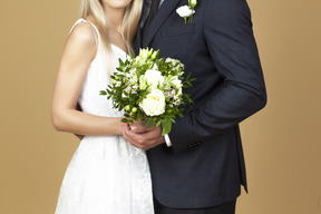 Bride and groom holding a wedding bouquet