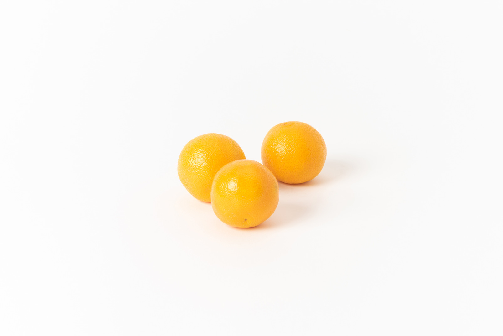 Three oranges on white background
