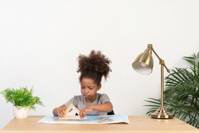 Good looking cute girl with books at the table