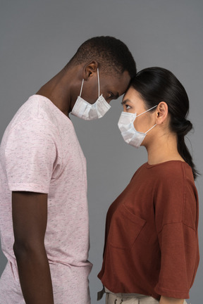 A young couple wearing face masks