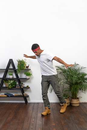 Good looking young man posing on the background of the apartment