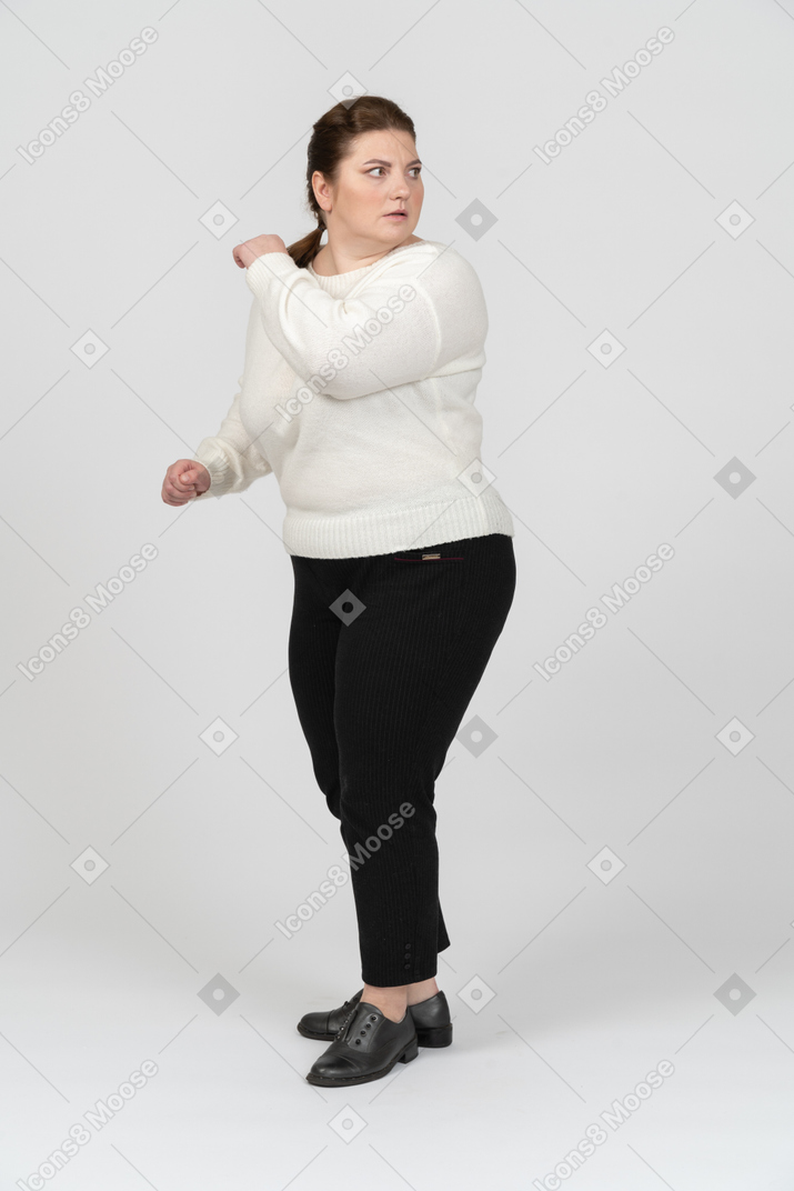Plus size woman in casual clothes moving