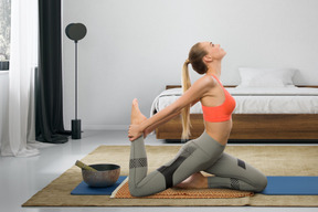 A woman doing yoga in her bedroom