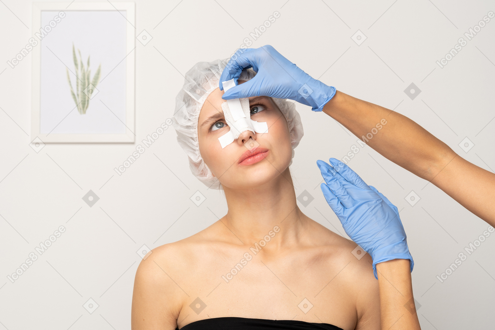 젊은 여성의 코에 붕대를 감는 의사