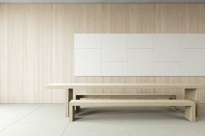 Room with wooden walls and a long table with benches